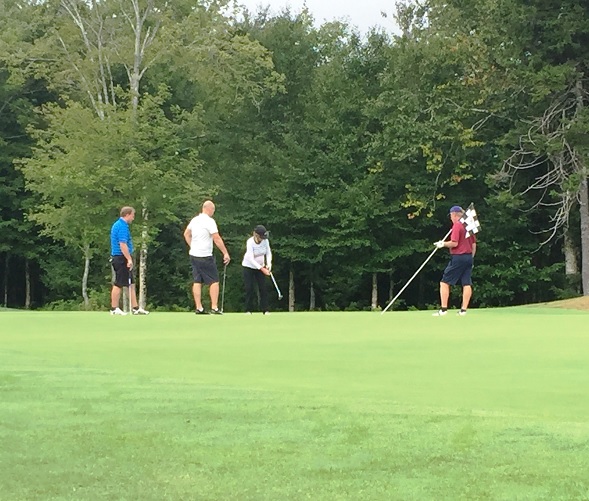 Golfers putting on a green during the 2015 Golf Classic.